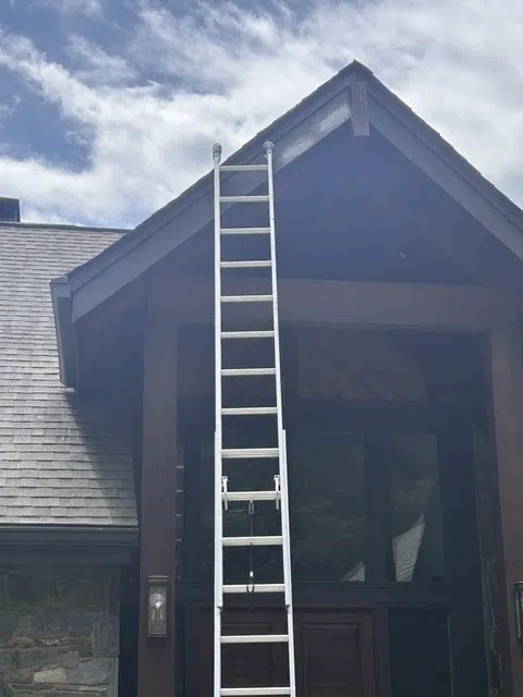 Extension ladder against house gable during exterior work — Father And Son Custom Painting in Raleigh