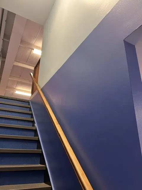 Stairwell with fresh blue and white painted walls — Father And Son Custom Painting in Raleigh