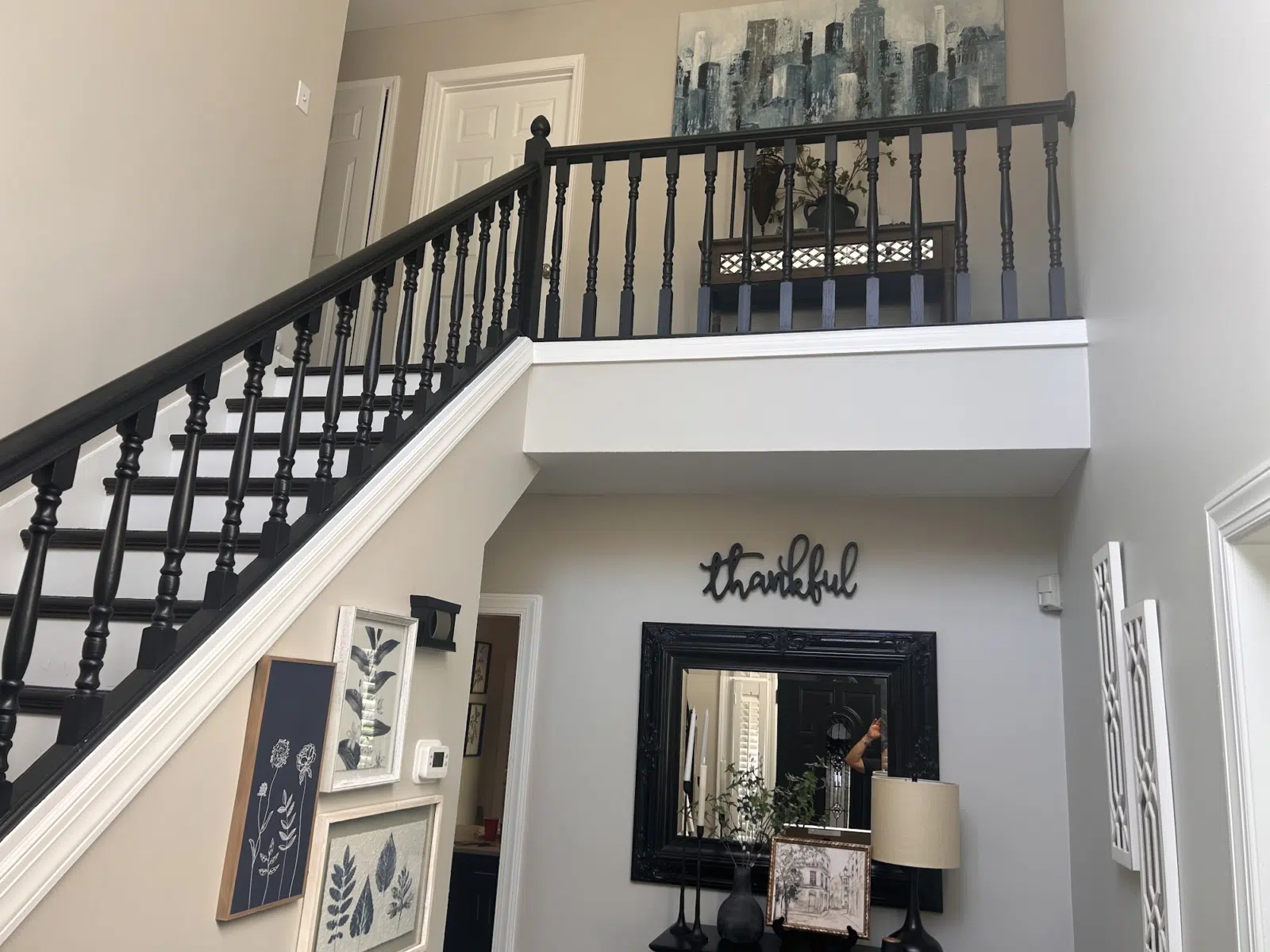 Foyer with black painted staircase railing and white trim — Father And Son Custom Painting in Raleigh
