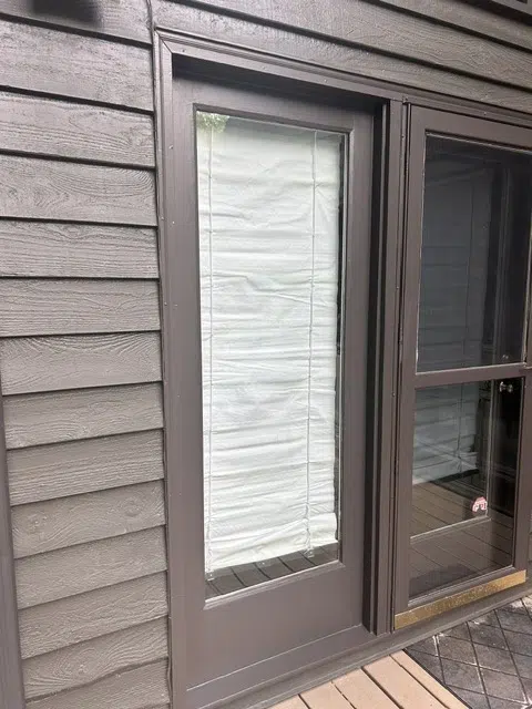 Freshly painted brown door on gray shingle siding — Father And Son Custom Painting in Raleigh